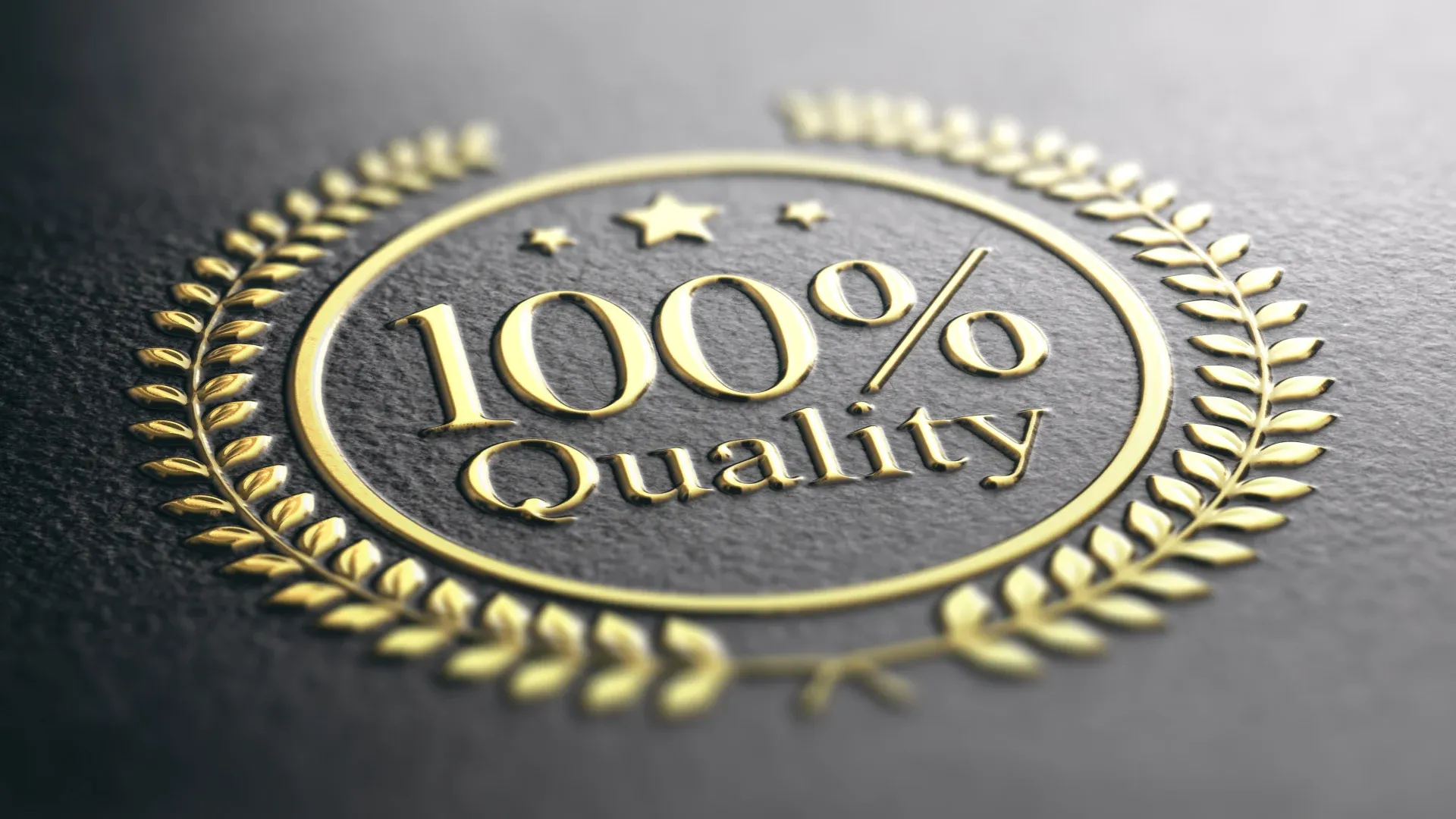 Gold "100% Quality" emblem with laurel wreath and stars on dark textured background, signifying excellence and premium standard.
