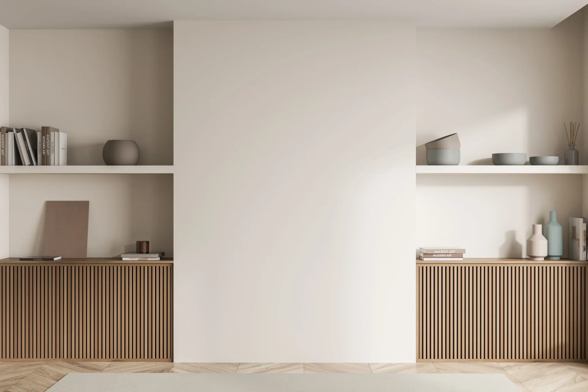 Minimalist living room with two sleek white shelves displaying neutral-toned books and pottery above brown slatted cabinets. The space feels serene and modern.