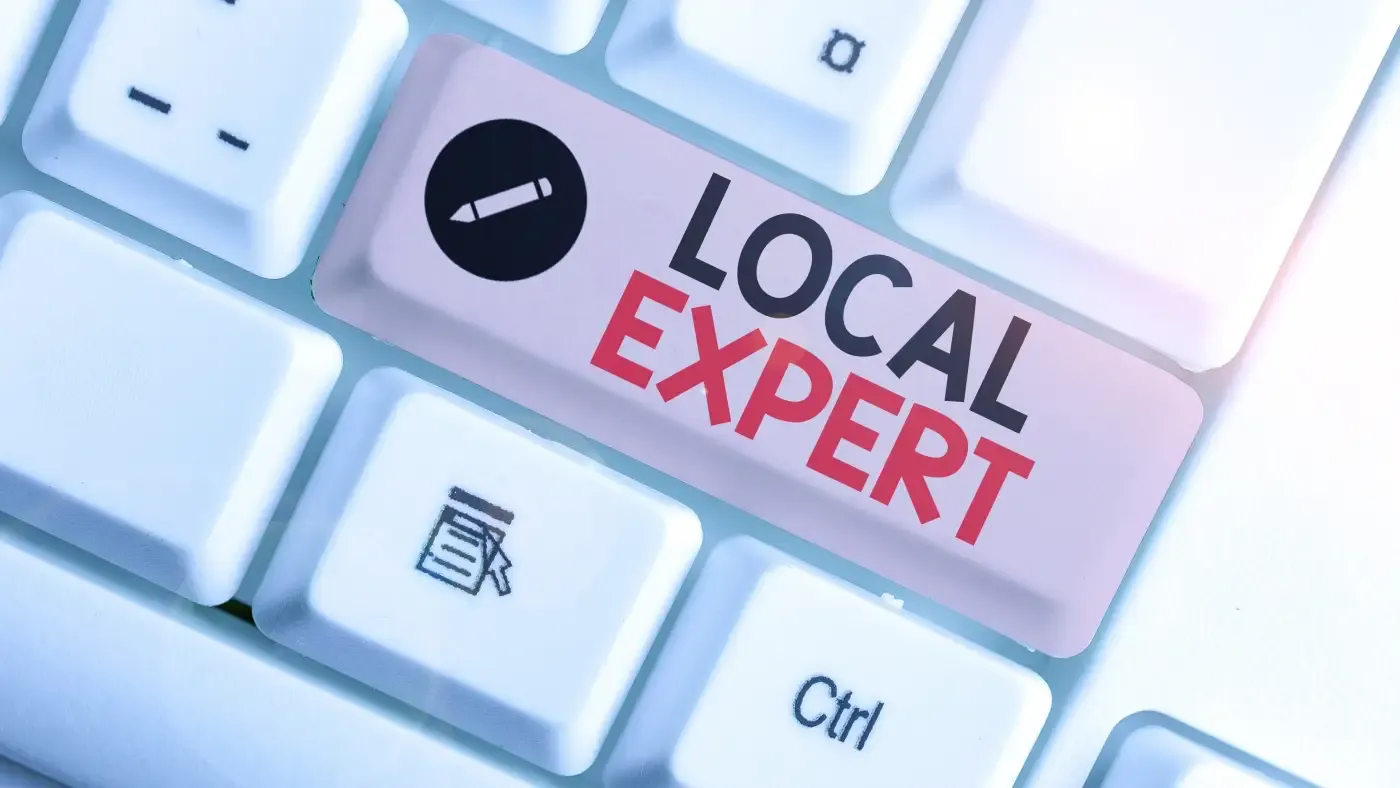 Close-up of a keyboard with a key labeled "Local Expert" in bold text. The image conveys authority and specialization in a specific area.