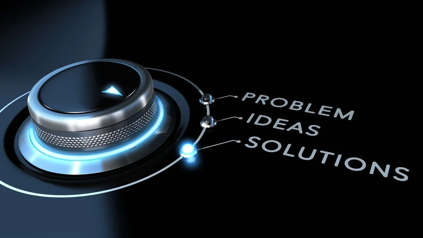 A sleek metallic dial on a dark background is set to "SOLUTIONS," with lines connecting to words: "PROBLEM," "IDEAS," and "SOLUTIONS." The scene conveys innovation.