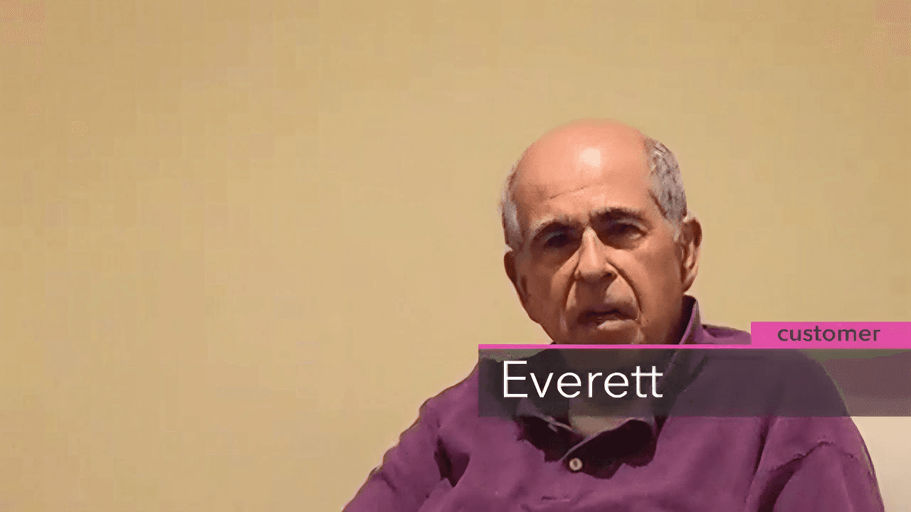 A man in a purple shirt sits in front of a plain beige background. Text overlay reads "Everett" and "customer." His expression is thoughtful.